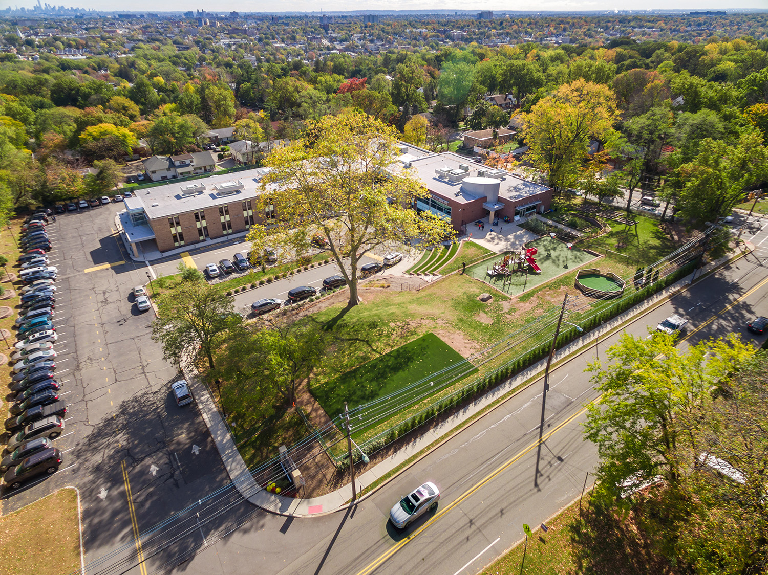 Aerial view of a street, parked cars and a school entrance in West Orange, NJ