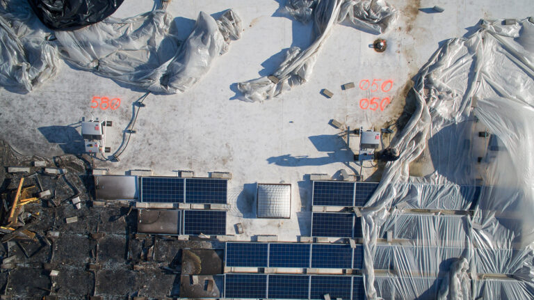 Fire-damaged commercial solar array documented during a drone inspection