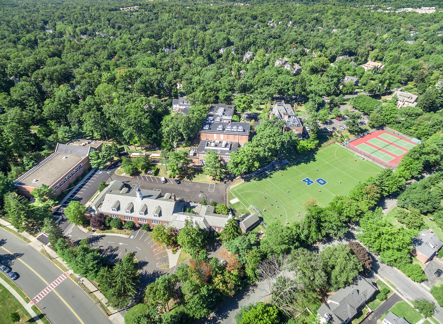 Drone view across maintained lawns and greens, Summit, NJ