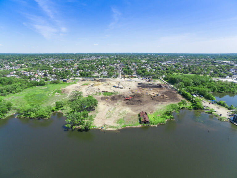 Aerial of soil and debris stockpiles at a Camden, NJ riverfront yard