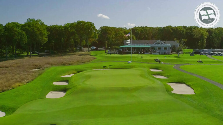 Aerial approach view over the green toward the distant clubhouse at St. George’s