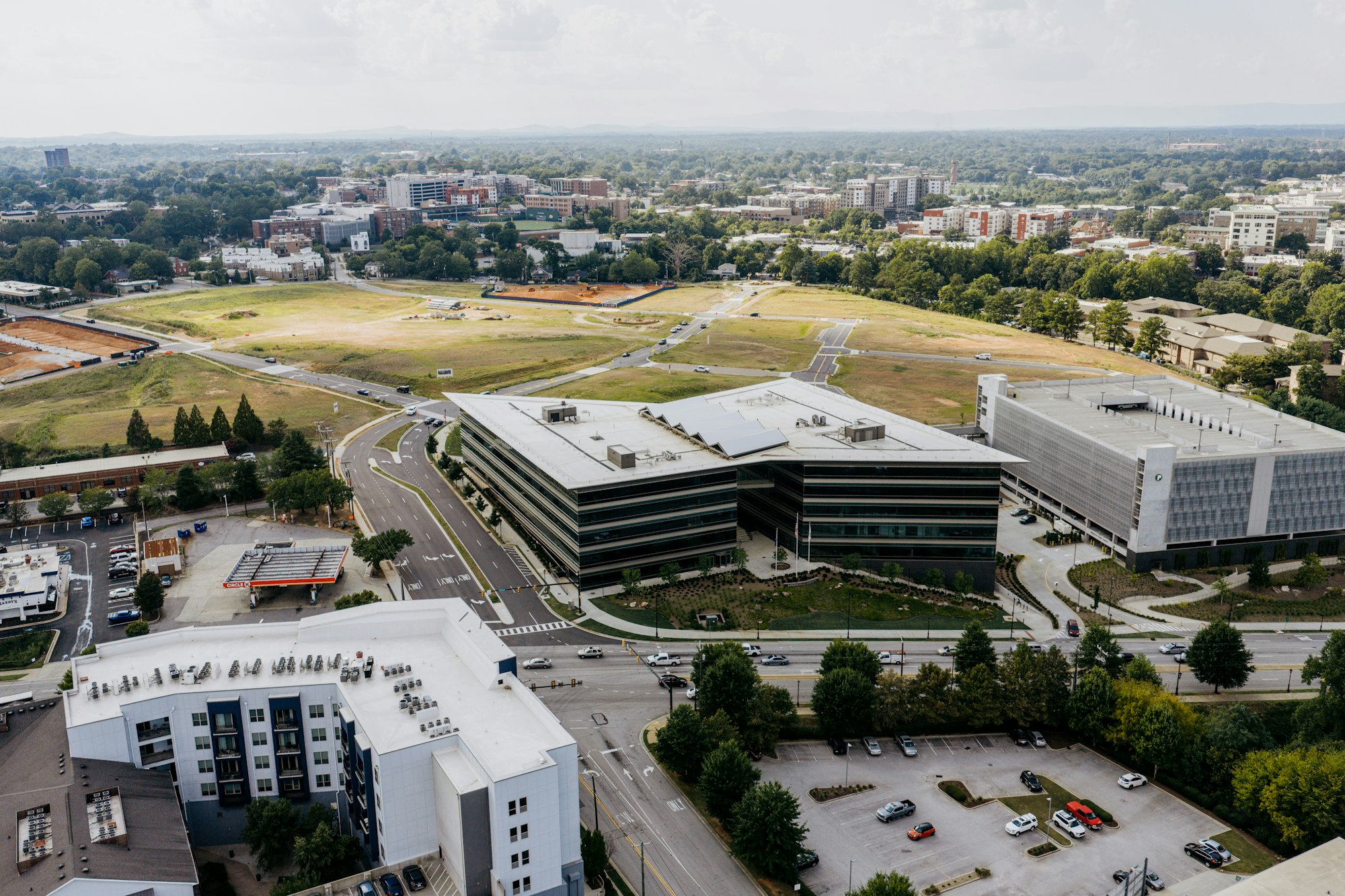 Drone view of an office campus with access roads, parking and nearby buildings