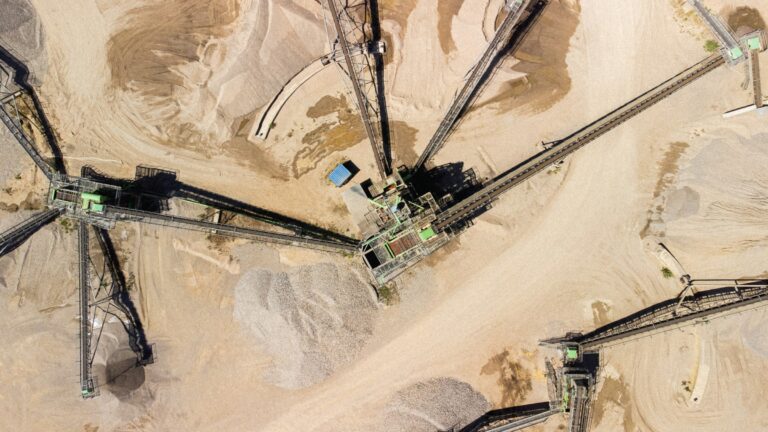 Aerial of aggregate stockpiles and conveyors at a material yard
