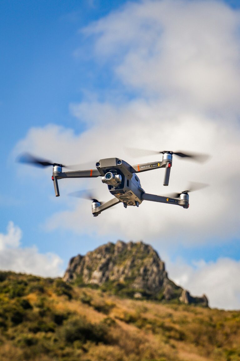 Camera drone in flight capturing aerial video
