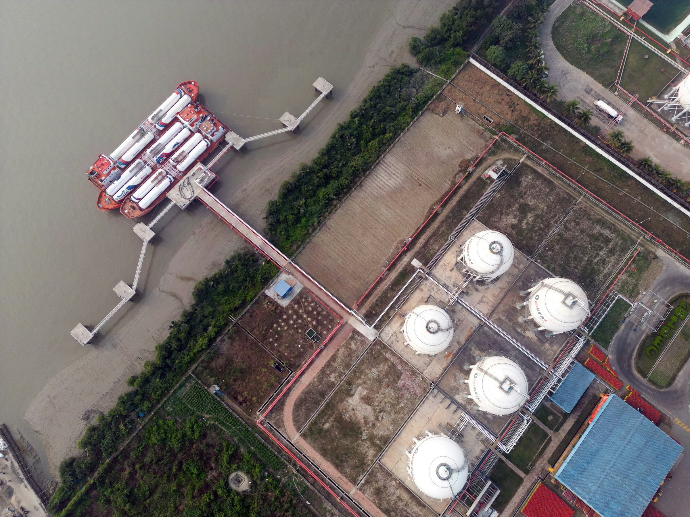 Aerial view of storage tanks and a marine pier
