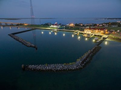 Drone shot of a waterfront construction barge and crane at work