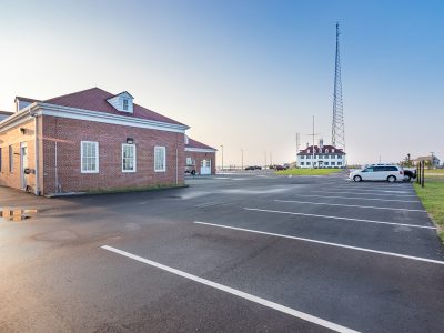 Waterfront brick building and new dock work photographed by drone