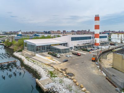 Drone aerial of commercial buildings along a retail corridor, Bronx, NY