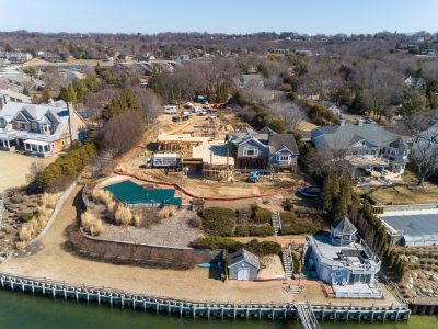 Aerial of a wooded estate property with pond during site development
