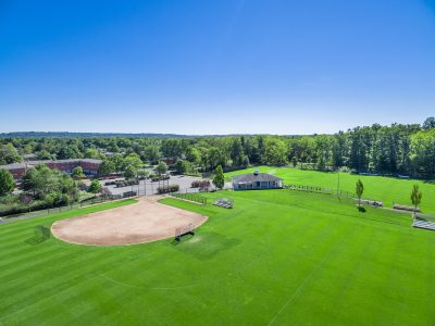 Aerial drone image of open green grounds and paths, Summit, NJ