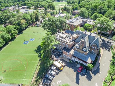 Aerial of school buildings, playing fields and parking in Summit, NJ