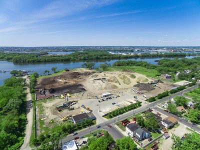 Aerial of material piles at a riverfront recycling yard in Camden, NJ